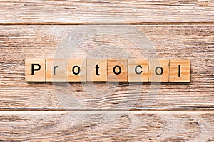 PROTOCOL word written on wood block. PROTOCOL text on wooden table for your desing, concept