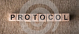 PROTOCOL word written on wood block. PROTOCOL text on wooden table for your desing, concept