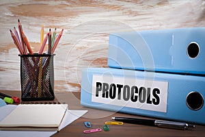 Protocols, Office Binder on Wooden Desk. On the table colored pe photo