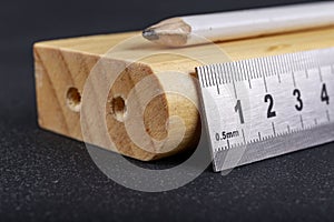 A protractor and a metal ruler to measure angles in a carpentry workshop. Accessories for measuring and drawing in a carpentry