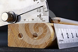 A protractor and a metal ruler to measure angles in a carpentry workshop. Accessories for measuring and drawing in a carpentry