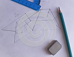 A protractor, pencil, and eraser lie on white paper with a drawn drawing.