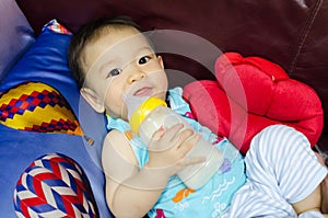 Protrait of baby boy with milk bottle