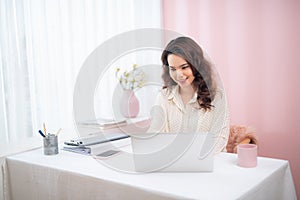 Protrait of Beautiful businesswoman sitting at desk and working with laptop computer