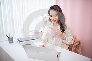 Protrait of Beautiful businesswoman sitting at desk and working with laptop computer