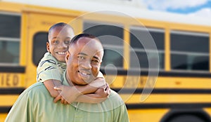 African American Dad and Son Piggyback Near School Bus