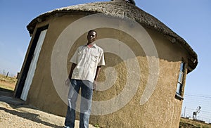 Proud African outside his home