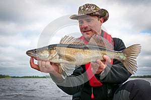 Proud angler with zander fish