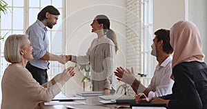 Proud company manager shake hand praise happy female employee