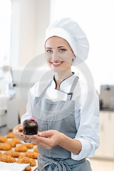 Confectioner showing some little sweets and cakes she made photo