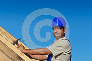 Proud construction worker on the roof