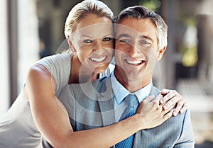 We are proud of each other. Cropped portrait of a smiling mature business couple hugging each other closely and smiling