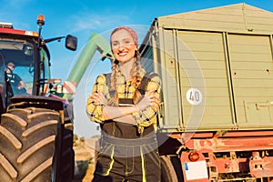 Proud famer standing in front of agricultural machinery