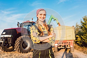 Proud famer standing in front of agricultural machinery