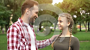 Proud father looking at daughter, congratulating with university entry, success