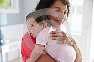 Proud Grandmother Holding Baby Granddaughter