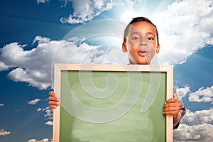 Proud Hispanic Boy Holding Blank Chalkboard Over S