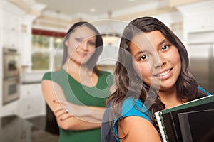 Proud Hispanic Mother and Daughter In Kitchen at Home Ready for