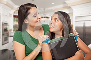 Proud Hispanic Mother and Daughter In Kitchen at Home Ready for