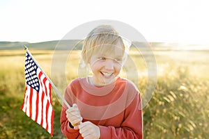 Proud little american boy holding his country flag