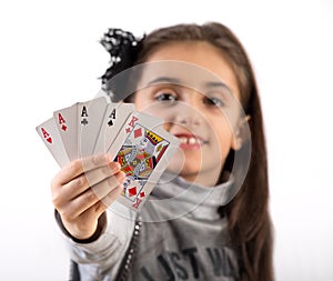 Proud little girl showing a winning poker hand