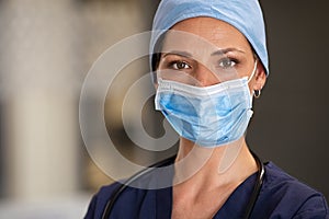 Proud nurse wearing surgical mask at hospital