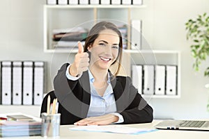 Proud office worker posing with thumbs up