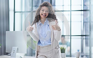 Proud office worker posing with thumbs up