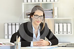 Proud office worker wearing eyeglasses looking at camera
