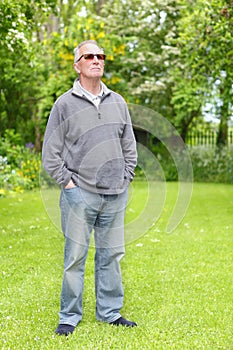 Proud old man on lawn photo