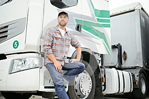 Proud Professional Trucker Standing in Front of His Truck. Trucking and Transportation Theme.