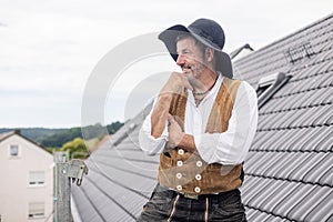 Proud Roofer standing on roof of home