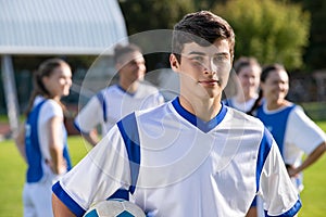 Proud soccer player with teammates in background