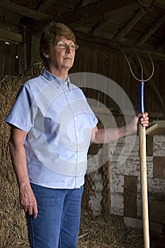 The Proud and Stoic Farmer Wife Standing in Barn