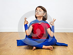 Proud superhero child practicing yoga and meditation for zen humour photo