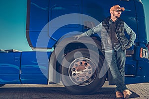 Proud Truck Driver in Front of His Heavy Duty Vehicle