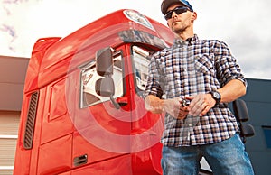 Proud Truck Driver in Front of His Vehicle