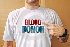 Proud volunteer blood donor wearing white t-shirt