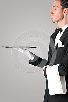 Proud waiter serving with tray photo