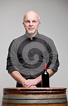 Proud wine maker man with a bottle