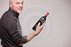 Proud wine maker man with a bottle