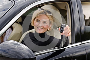 Proud woman driver holding up her car keys