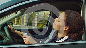 Proud woman new car owner sitting in driver`s seat