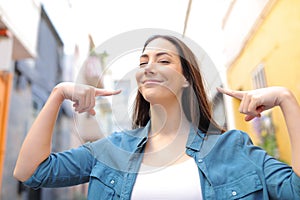 Proud woman pointing herself in the street