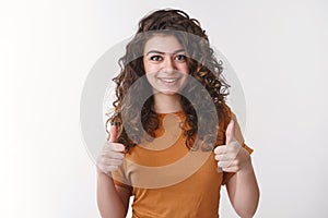 Proud you did great. Portrait happy impressed attractive supportive armenian girl wearing orange t-shirt show thumbs-up