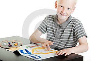 Proud young boy artist doing finger painting
