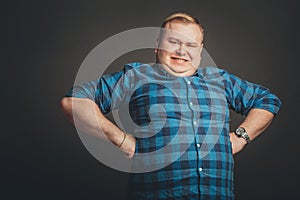 Proud young man on black background