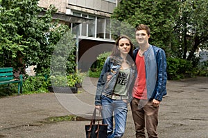 Proud young man holding his girlfriend, posing