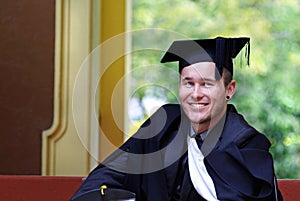 Proud young man university graduate after graduation ceremony