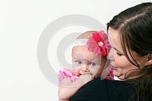 Proud young mother holding baby